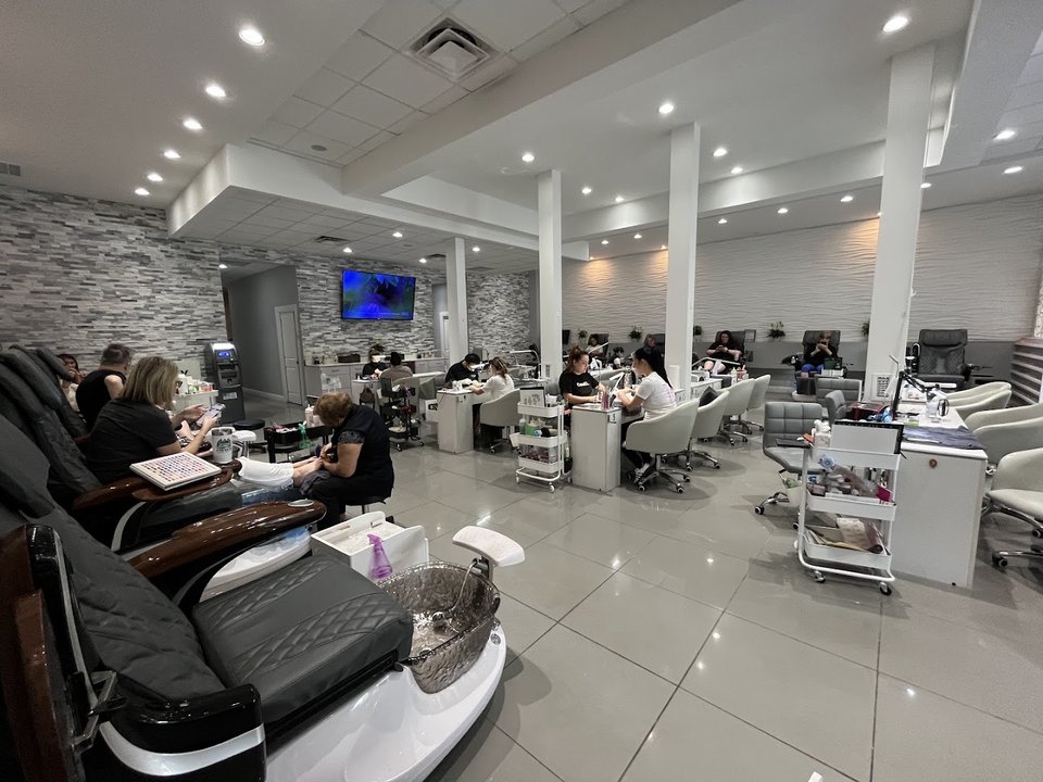 Pedicure chairs line a clean salon interior.